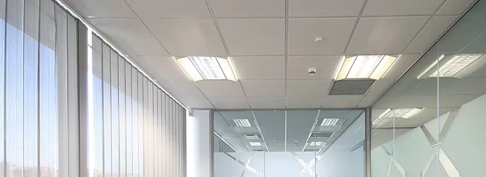 QuietTile ACT installed in a conference room ceiling with partial height glass walls.