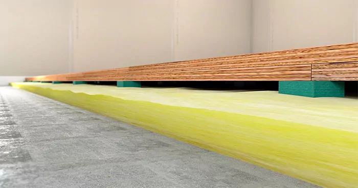 RIM Floating floor isolation system supporting a plywood floor buildup
