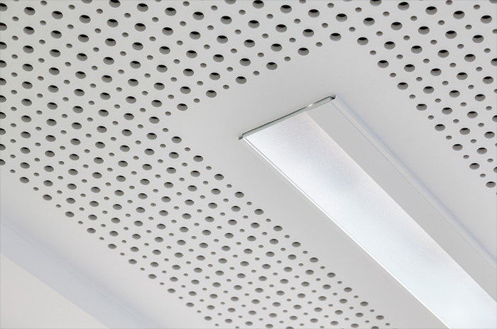 Mud-in linear light fixture in a perforated drywall acoustical ceiling.