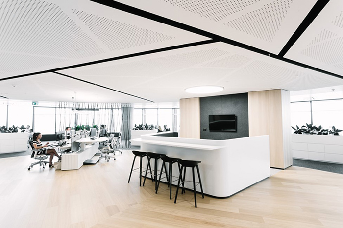 Vogl perforated sound absorbing gypsum with geometric pattern in an open plan office.