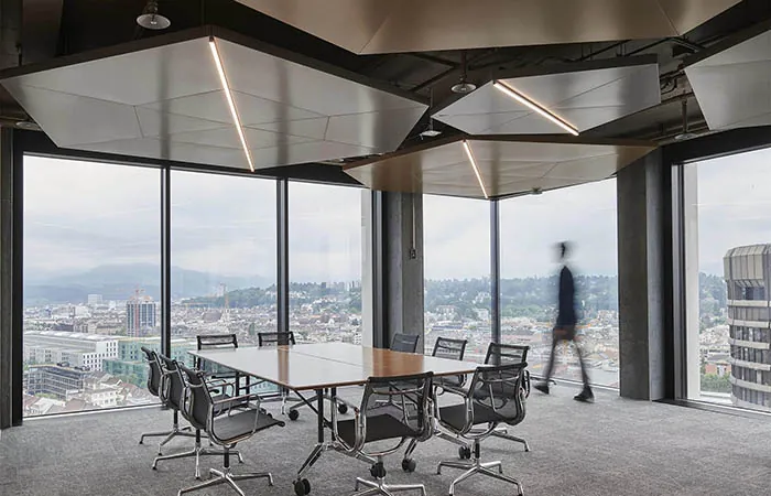 dur-solo metal acoustical ceiling clouds with integrated linear lighting in a geometric configuration