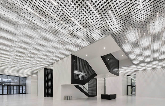Quadra Decor perforated metal open cell ceiling in a large lobby space