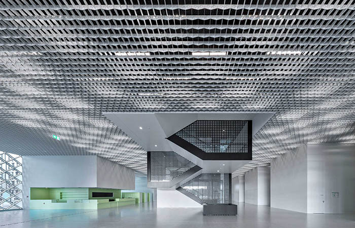 Quadra Decor perforated metal open cell ceiling in a large lobby space