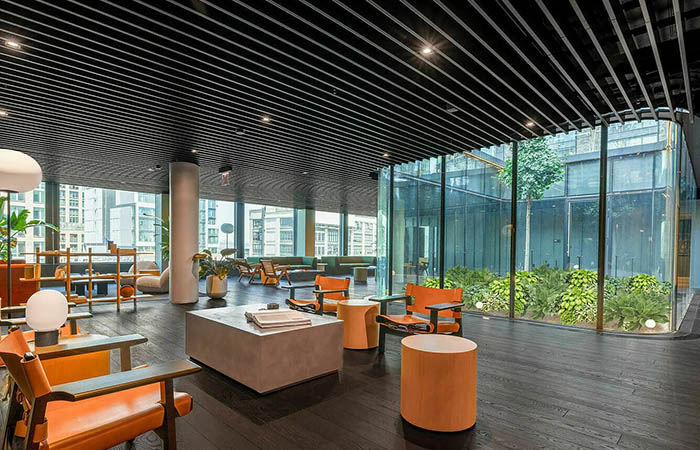 Black linear metal baffles in an urban hotel lobby