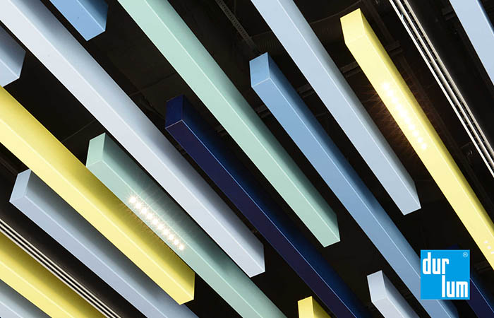 Detailed view of durlum Polylam acoustical baffles with multiple colors and lighting integration