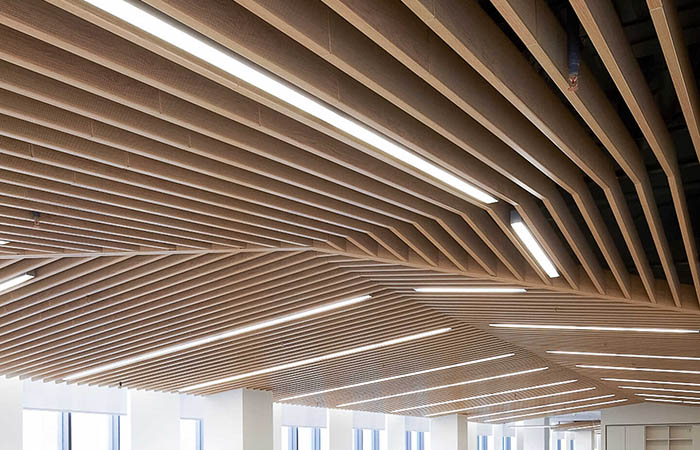 Close up view of wood printed metal acoustical baffles in a complex geometric shape.