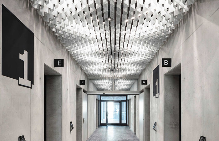 Elevator lobby with LIVA metal ceiling and diffuse light pattern.