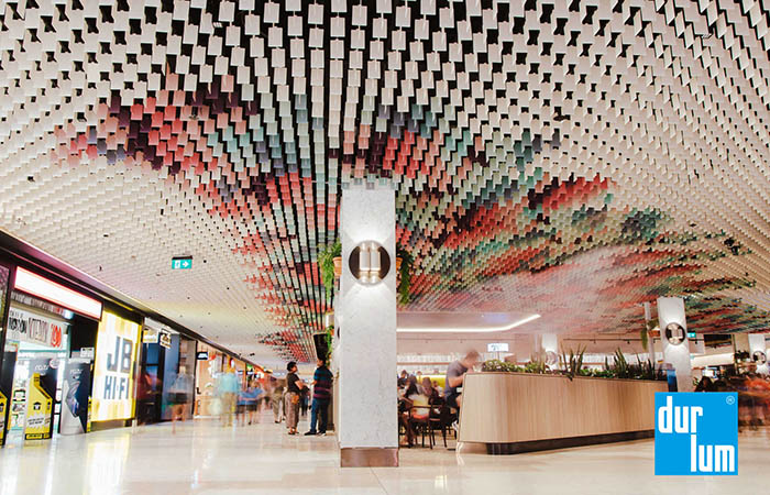 LIVA metal ceiling with multi-color powder colored blades in a shopping mall.