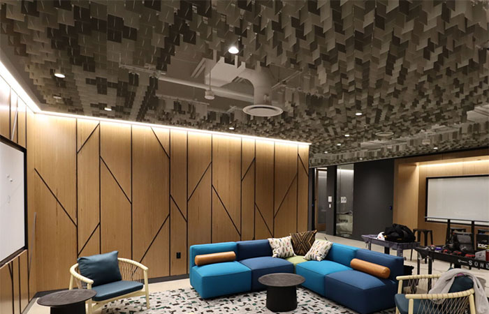 Multi-toned grayscale LIVA metal blade open cell ceiling in an office huddle space.