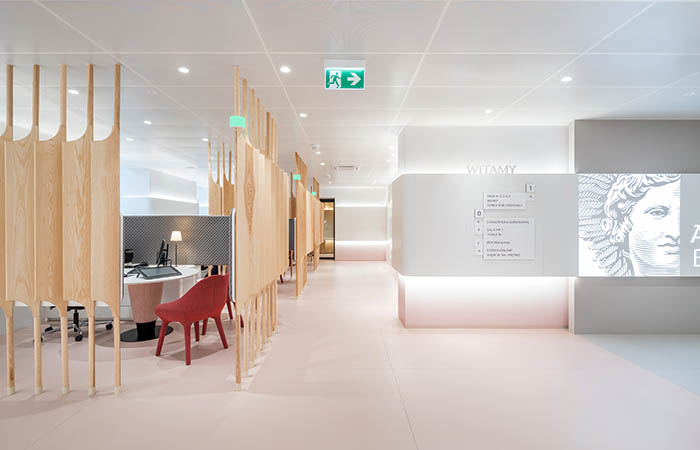 Large format white metal perforated acoustical ceiling panels in a high end retail space