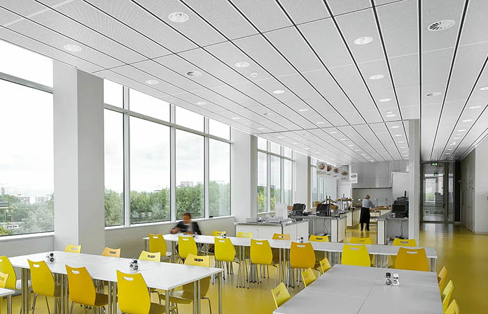 Rectangular metal acoustical ceilings in cafeteria dining area