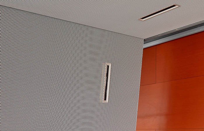 Detailed view of expanded metal mesh ceiling and wall panel.