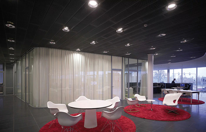 Expanded metal mesh ceiling in lobby circulation around private meeting rooms.