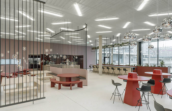 Ticell-N woven metallic open cell ceiling in an office dining room