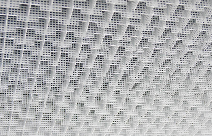 Detailed view of the peforated woven metal Ticell-N open cell ceiling panel